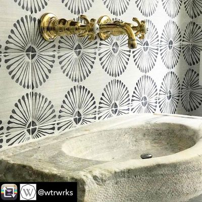 Stone bathroom sink with gold faucet image